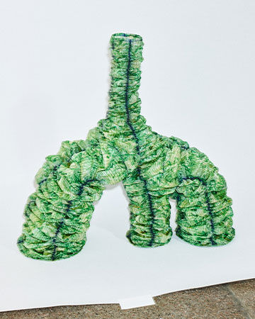 Jens Ole &Aacute;rnason material installation: An abstract, three-legged organic sculpture crafted entirely from textured green plant-based tiles