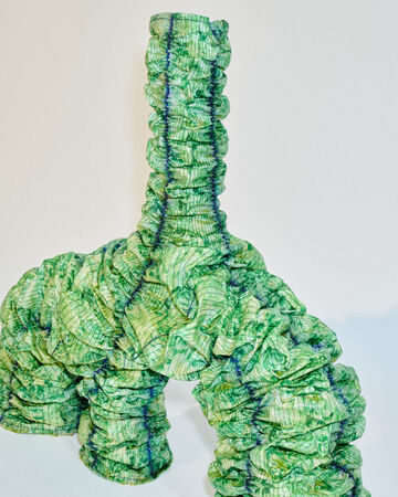 Jens Ole &Aacute;rnason close-up: Detailed look at the overlapping textured green bio-material tiles covering the surface of the sculpture